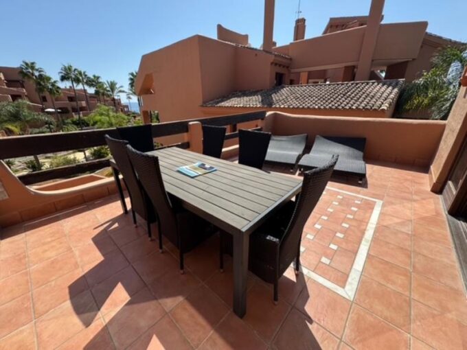 Outdoor table Elegant Beachfront Apartment for Sale in New Golden Mile