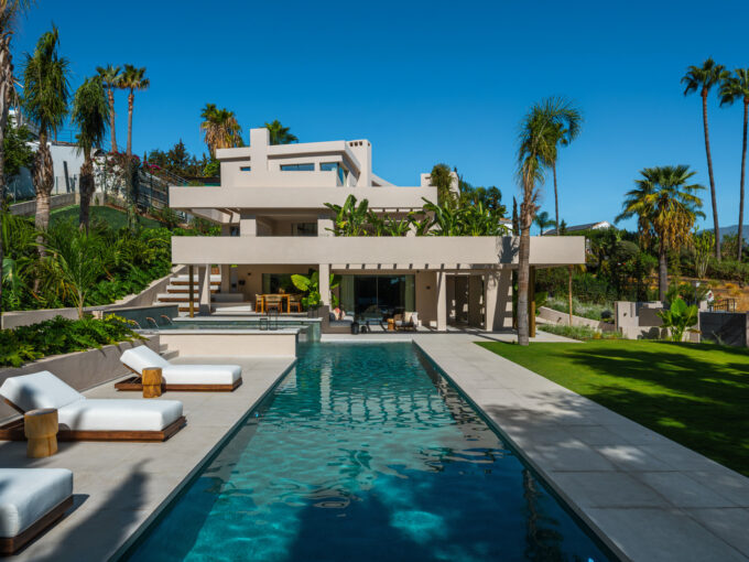 Poolside terrace at a contemporary luxury villa for sale in Nueva Andalucía.