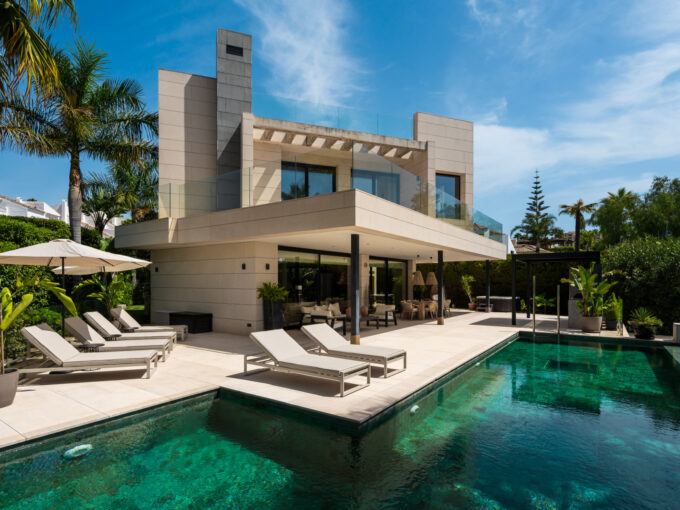 Poolside terrace at a luxury villa for sale in Marbella, offering space to relax beside the private swimming pool.